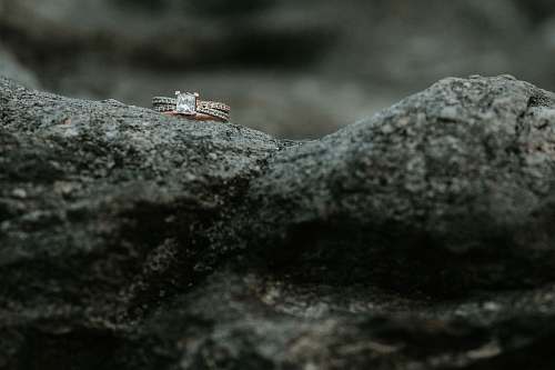 grey gold-colored clear gemstone encrusted ring on rock roan mountain